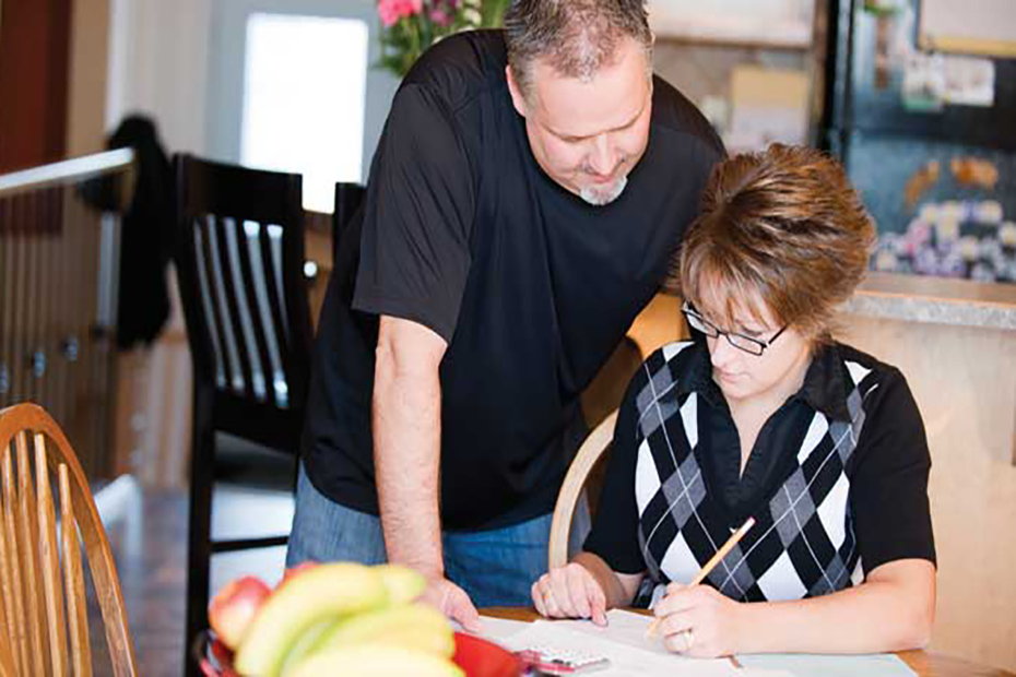 man and woman calculating bill payments